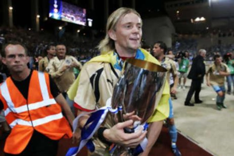 The Zenit St Petersburg player Anatoly Tymoshchuk holds the trophy after winning the European Super Cup.