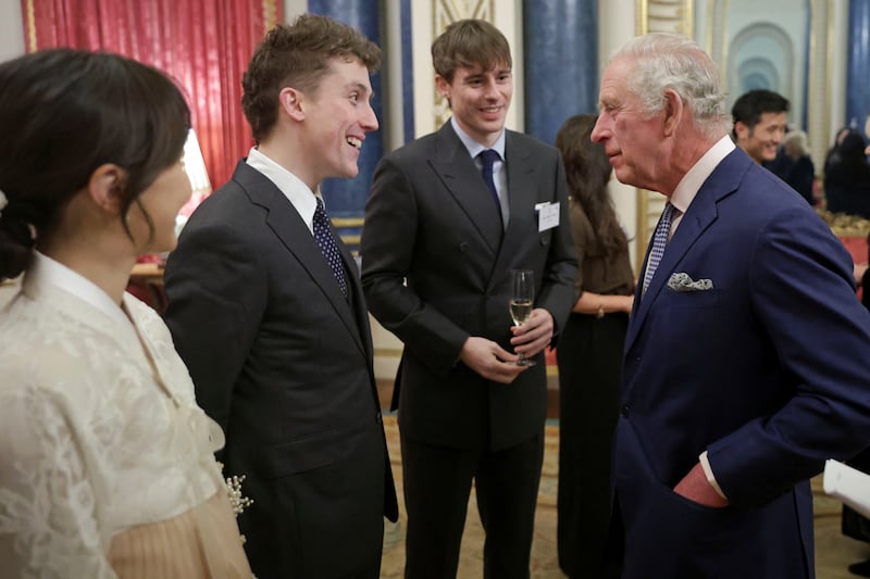 King Charles meets Oliver Kendal and Joshua Carrot, also known as YouTubers the Korean Englishmen, at the reception. Reuters