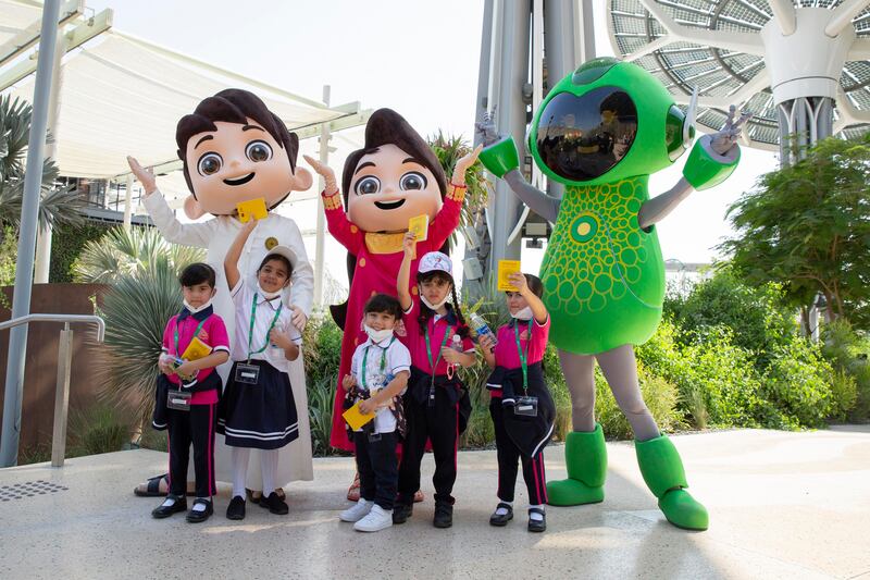 Expo 2020 mascots Rashid, Latifa and Alif with children at the Earth Plaza.