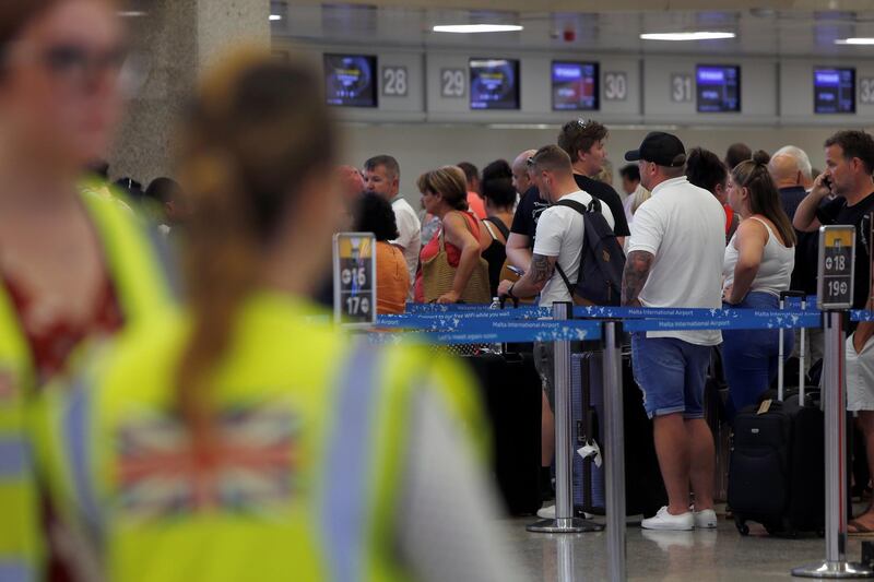 Thomas Cook passengers queue up in a check-in service after the collapse of the travel firm, at Malta International Airport, Malta September 23, 2019. REUTERS/Darrin Zammit Lupi