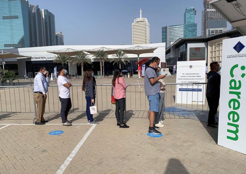 People queue for the vaccine near DIFC in Dubai. AFP