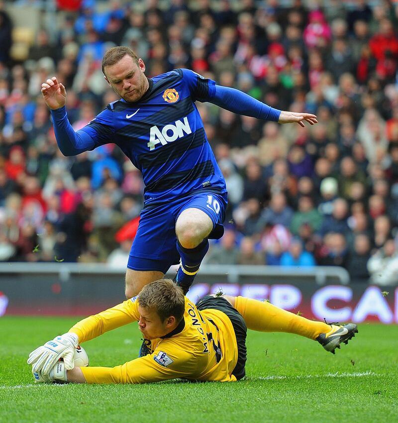 SUNDERLAND, ENGLAND - MAY 13: Wayne Rooney of Manchester Uinted in action with Simon Mignolet of Sunderland during the Barclays Premier League match between Sunderland and Manchester United at the Stadium of Light on May 13, 2012 in Sunderland, England.  (Photo by Michael Regan/Getty Images)