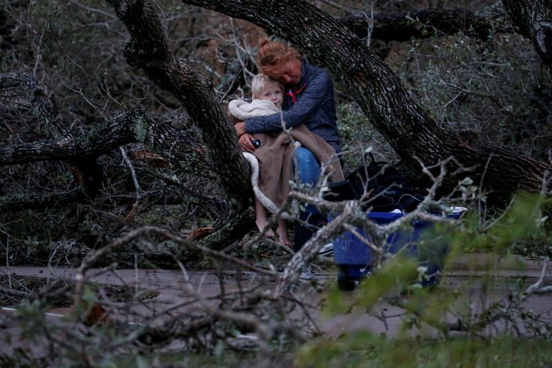 Lisa Rehr holds her four-year old son Maximus, after they lost their home to Hurricane Harvey, as they await to be evacuated with their belongings from Rockport, Texas. Adrees Latif / Reuters