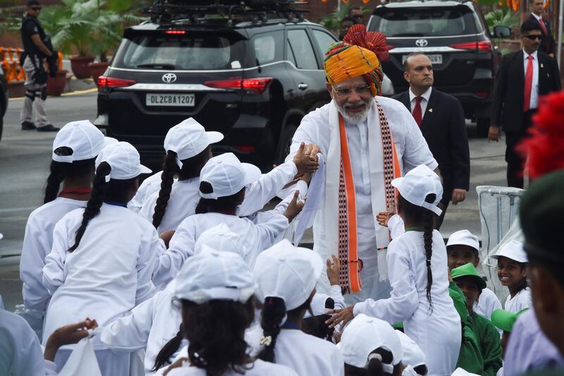 Narendra Modi greets children during a ceremony at the Red Fort in New Delhi. AFP