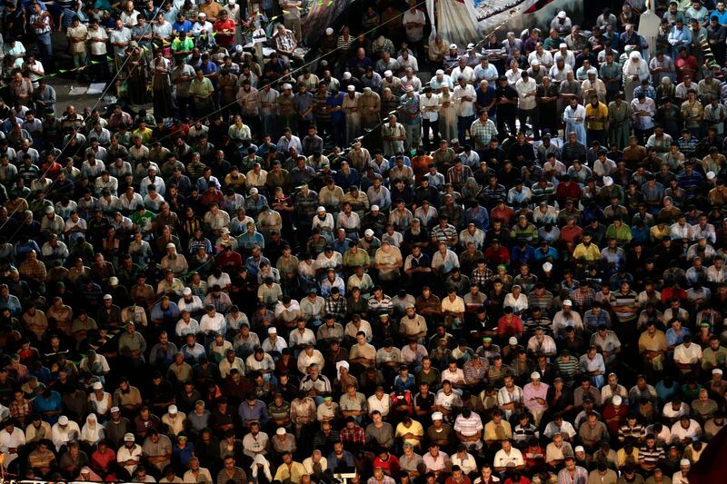 Supporters of Egypt's ousted President Mohammed Morsi pray at Nasr City, where protesters have installed a camp and hold daily rallies, in Cairo, Egypt, Sunday, July 28, 2013. Deadly clashes broke out during funerals of slain supporters of Egypt's ousted Islamist president Sunday, as the supreme leader of the Muslim Brotherhood urged his followers to stand fast after more than 80 of them were killed in weekend violence. (AP Photo/Hassan Ammar) *** Local Caption ***  Mideast Egypt.JPEG-0dab4.jpg