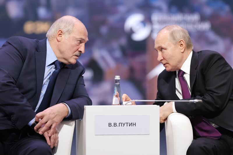 Russian President Vladimir Putin, right, and Belarusian President Alexander Lukashenko speak during an event in Moscow. AP