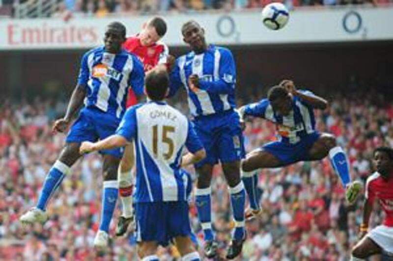 Arsenal's Thomas Vermaelen, centre, heads home the opener at the Emirates Stadium.