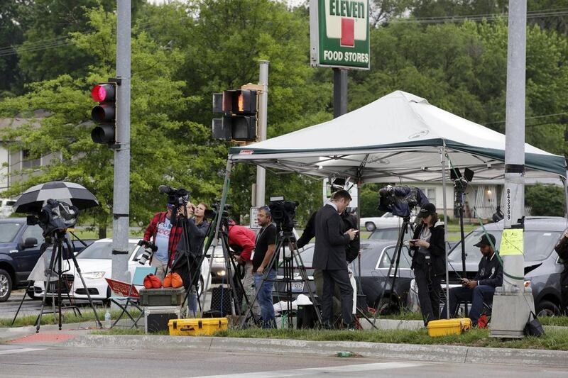 Media wait outside the main gate of Fort Leavenworth prison in Kansas on May 17, 2017, trying to get a shot of Chelsea Manning leaving the facility. Colin E Braley / EPA