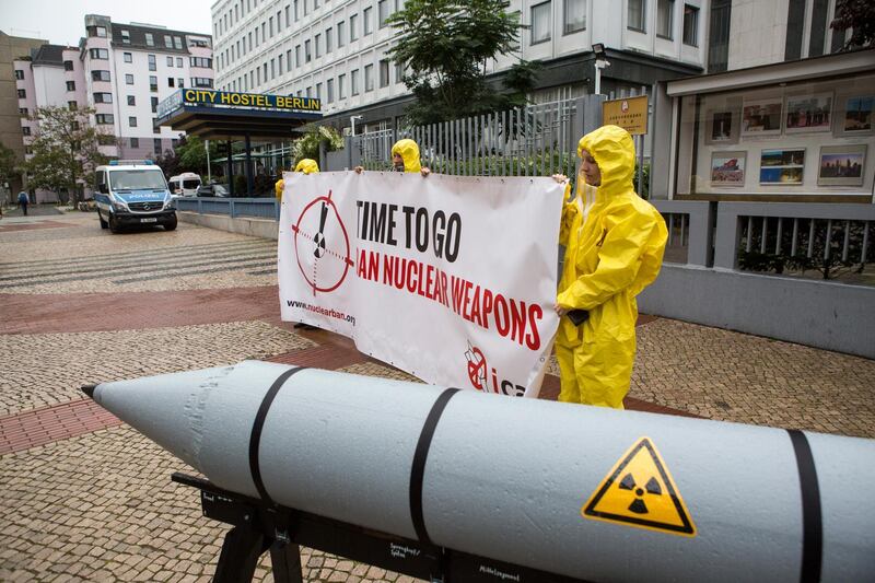 BERLIN, GERMANY - SEPTEMBER 13: International campaign to abolish Nuclear Weapons (ICAN) activists wearing yellow hazard suits are seen next to a Styrofoam effigy of a nuclear bomb after protesting in front of the North Korean Embassy on September 13, 2017 in Berlin, Germany. The protests, which were organized by anti-nuclear and pro-peace group ICAN, took place at both the North Korean and US embassies. (Photo by Omer Messinger/Getty Images)