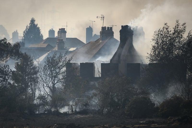 Smoke rises from Wennington neighbourhood fires in England on Tuesday. Getty