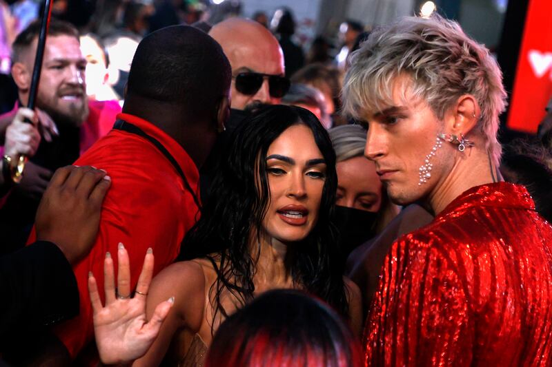 Irish mixed martial artist Conor McGregor (L) tries to push his way through toward US rapper Machine Gun Kelly (R) as US actress Megan Fox (C) stands in the middle as what appears to be a fight breaks out between the two men during the arrivals on the red carpet for the MTV Video Music Awards at the Barclays Center in Brooklyn, New York, USA, 12 September 2021.   EPA / JASON SZENES