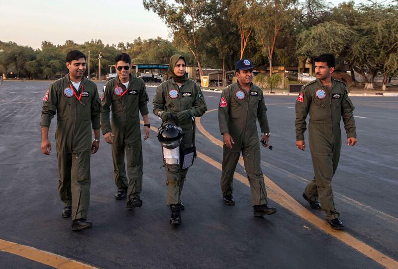 Ayesha Farooq, 26, (C) Pakistan's only female war-ready fighter pilot, walks with Wing Commander of Squadron 20 Nasim Abbas (2nd R) and her colleagues toward a Chinese-made F-7PG fighter jet at Mushaf base in Sargodha, north Pakistan June 6, 2013. Farooq, from Punjab province's historic city of Bahawalpur, is one of 19 women who have become pilots in the Pakistan Air Force over the last decade - there are five other female fighter pilots, but they have yet to take the final tests to qualify for combat. A growing number of women have joined Pakistan's defence forces in recent years as attitudes towards women change. Picture taken June 6, 2013.  REUTERS/Zohra Bensemra (PAKISTAN - Tags: MILITARY SOCIETY) *** Local Caption ***  ZOH03_PAKISTAN-AIRF_0612_11.JPG