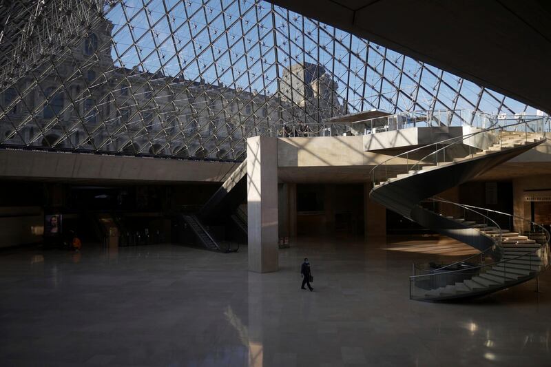 A man walks through the deserted Louvre museum in Paris on February 11, 2021. AP