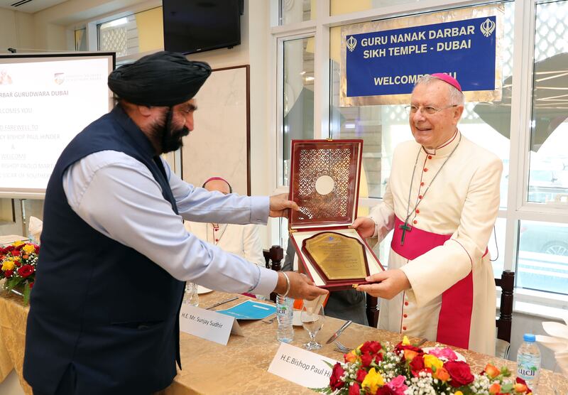 Dr Surender Singh Kandhari presents Bishop Hinder with a plaque commemorating his 18 years of service in the Emirates.
