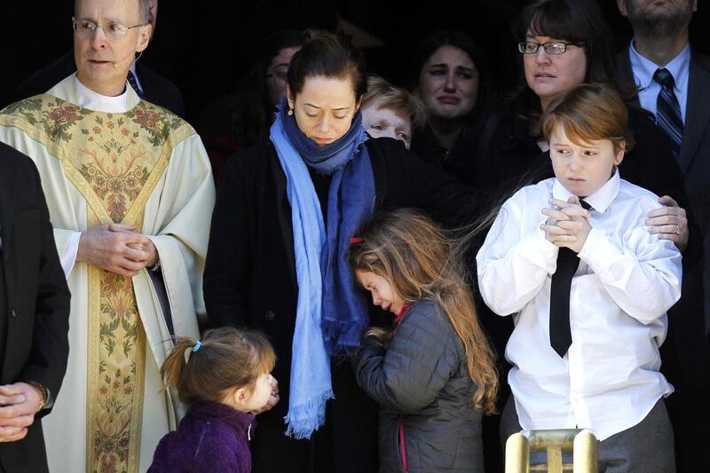 Mimi O'Donnell, centre, the estranged partner of the late actor Philip Seymour Hoffman, comforts her daughter Tallulah, along with daughter Willa, left, and son Cooper, at his funeral on Friday. Jason DeCrow / AP