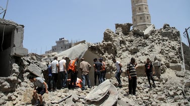 Palestinians gather as rescuers search for casualties at the site of Israeli strikes that hit a residential building and destroyed shops at Gaza's Old City market in Gaza city July 4, 2024. Reuters