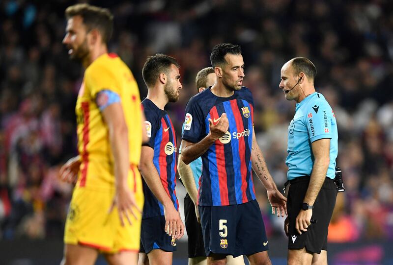 Barcelona captain Sergio Busquets talks with referee Mateu Lahoz at the end of the match. AFP