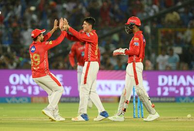 Kings XI Punjab bowler Mujeeb Ur Rahman (C) celebrates with teammates after dismissing Rajasthan Royals batsman Jos Buttler during the 2018 Indian Premier League (IPL) Twenty20 cricket match between Rajasthan Royals and Kings XI Punjab at the Sawai Mansingh Stadium in Jaipur on May 8, 2018. / AFP PHOTO / SAJJAD HUSSAIN / ----IMAGE RESTRICTED TO EDITORIAL USE - STRICTLY NO COMMERCIAL USE----- / GETTYOUT