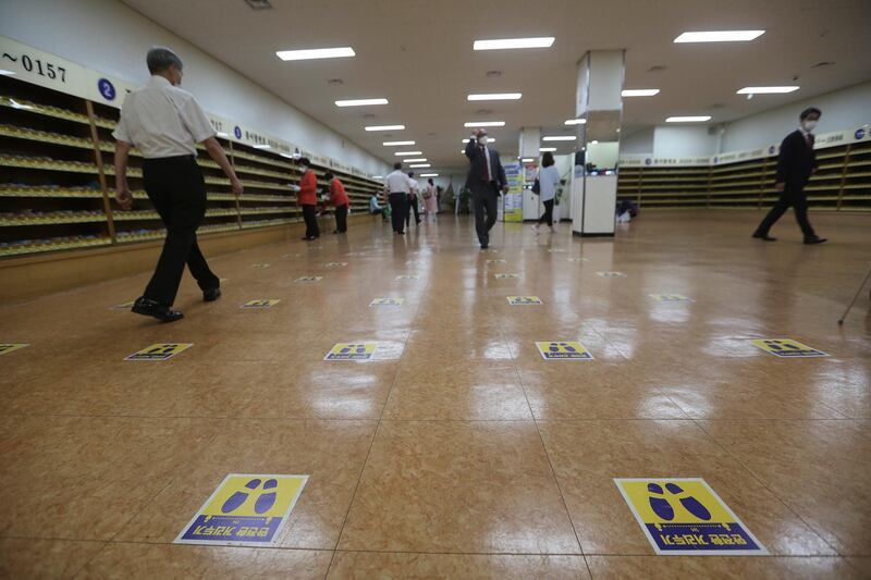 Social distancing signs are seen on the floor at the Yoido Full Gospel Church in Seoul, South Korea. The signs read: "Safe Distance." AP Photo