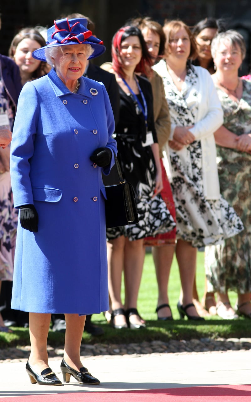 Queen Elizabeth II, in blue, visits St John's College at the University of Cambridge, England, on April 27, 2011. Getty Images