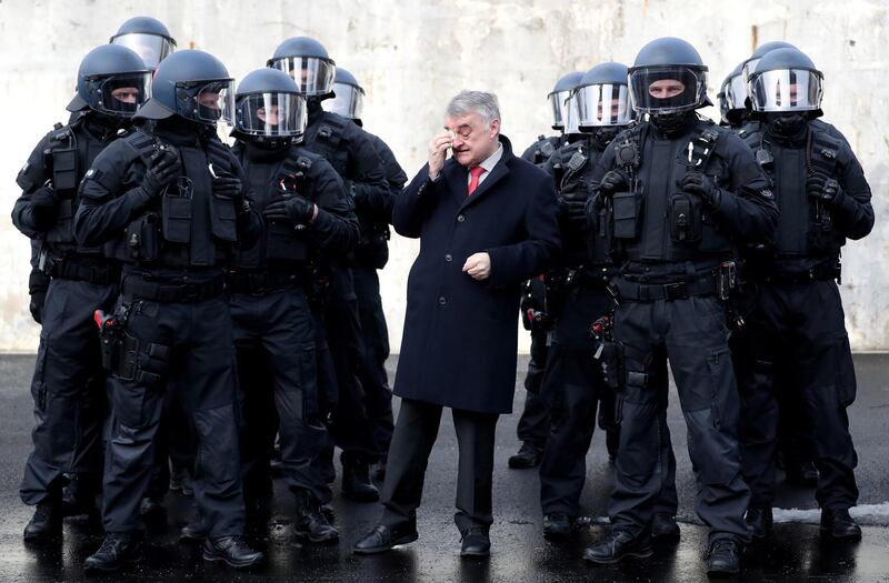 epa08673040 (FILE) - Herbert Reul (C), Interior Minister of North Rhine-Westphalia, presents North Rhine-Westphalia's unit for arrests and securing evidence 'BFE' (Beweissicherungs- und Festnahmeeinheiten) in Bochum, Germany, 04 February 2019.(Reissued 16 September 2020). German Interior Minister Herbert Reul said on 16 September 2020 that more than 30 police stations and private apartments have been raided and several mobile phones have been confiscated after right wing extremist police officers have been found spreading Nazi propaganda in chat groups. At least 29 police officer have been suspended and will undergo disciplinary measures according to Reul. The minister added that neo Nazis and right-wing extremists have no police in the German police force, promising that he will exert all the necessary efforts to remove the  involved police officers from the service.  EPA/FRIEDEMANN VOGEL *** Local Caption *** 54957220