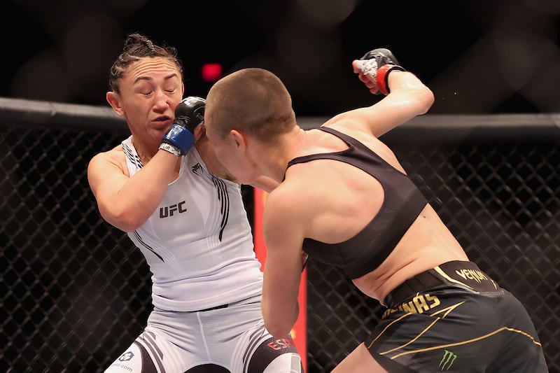 Rose Namajunas throws a right on Carla Esparza in their women’s strawweight championship bout at UFC 274. Getty
