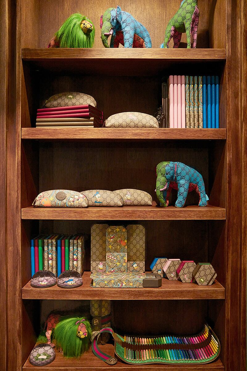 A cabinet filled with patchwork toys and notebooks.