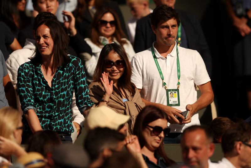 Emma Raducanu's mum Renee Zhang, middle, waves from the stands. Getty Images