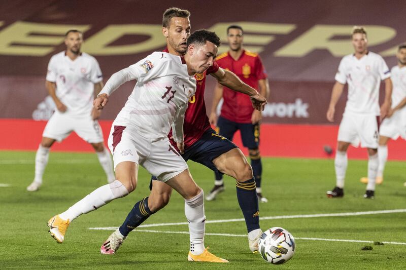 Switzerland's Ruben Vargas fights for the ball against Spain's Sergio Canales. EPA