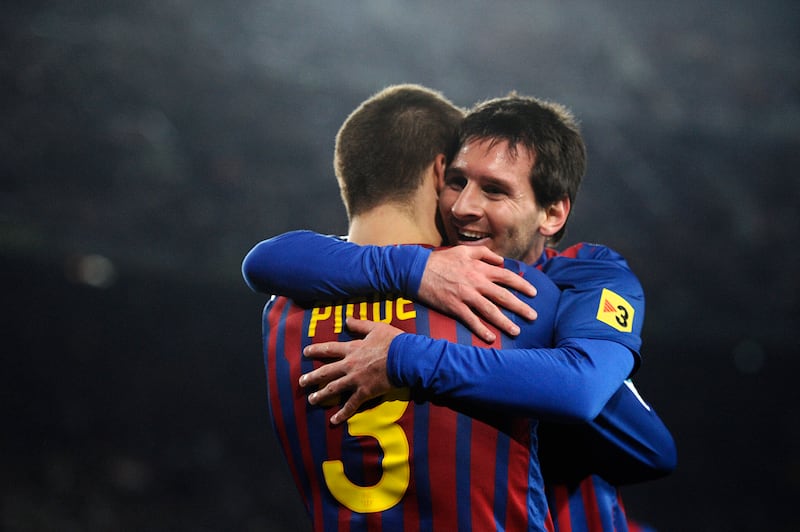 Lionel Messi, right, was a longtime Barcelona teammate of Gerard Pique before the former's departure for PSG in 2021. On Thursday Pique announced Saturday's La Liga match against Almeria will be his final match for the club at Camp Nou. Getty Images