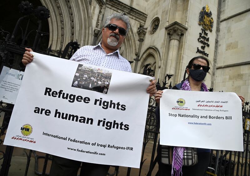 Demonstrators protest outside the Royal Courts of Justice in London, while a legal case is heard over halting a planned deportation of asylum seekers from Britain to Rwanda. Reuters