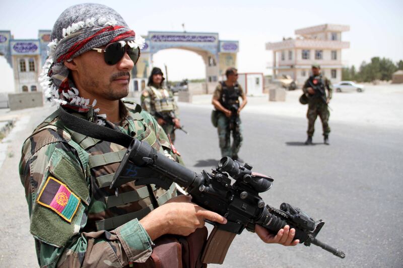 Afghan soldiers stand guard at a check point in Herat, Afghanistan.