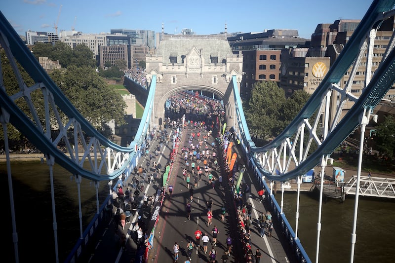 Runners cross over Tower Bridge during the London Marathon, on Sunday, October 3. AP