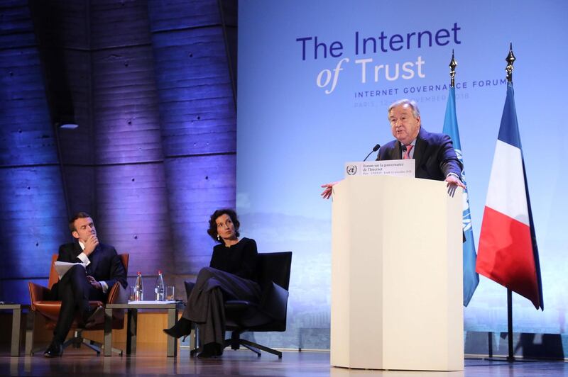 UN Secretary-General Antonio Guterres (R) delivers a speech flanked by French President Emmanuel Macron (L) and UNESCO chief Audrey Azoulay (C) during  the opening session of the Internet Governance Forum (IGF) at the UNESCO headquaters in Paris, on November 12, 2018. Fifty-one states, including all EU members, have pledged their support for a new international agreement to set standards on cyberweapons and the use of the internet, the French government said on November 12. China, Russia and the United States did not sign the pledge, reflecting their resistance to setting standards for cyberweapons which are at the cutting edge of modern warfare.  / AFP / POOL / Ludovic MARIN
