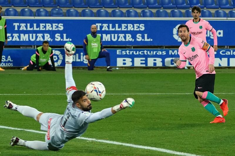 Messi shoots against Alaves goalkeeper Fernando Pacheco. AFP