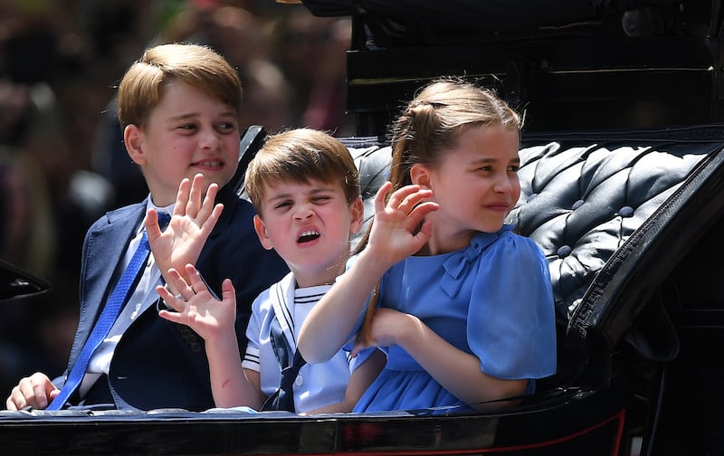 Prince George, Prince Louis and Princess Charlotte ride in an open carriage on The Mall during the platinum jubilee celebrations. EPA