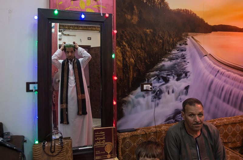 A Muslim singer wears his sufi clothing before singing Islamic songs (Anasheed) at his home  in Cairo, Egypt. EPA