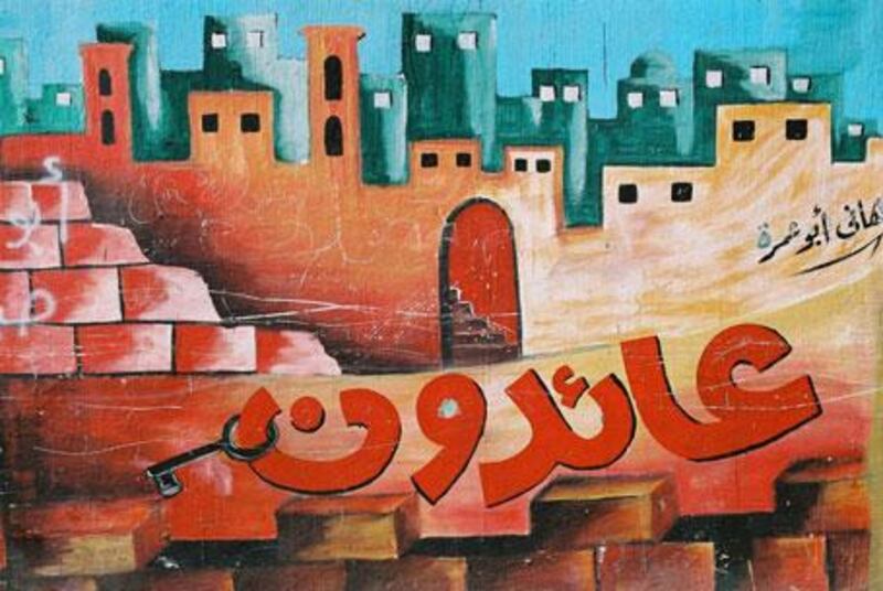 The calligraphy says 'We are returning' in this mural from the Gaza Strip. The Palestinian refugee's key of homecoming - a symbol of both defiance and yearning - hangs from the lettering.