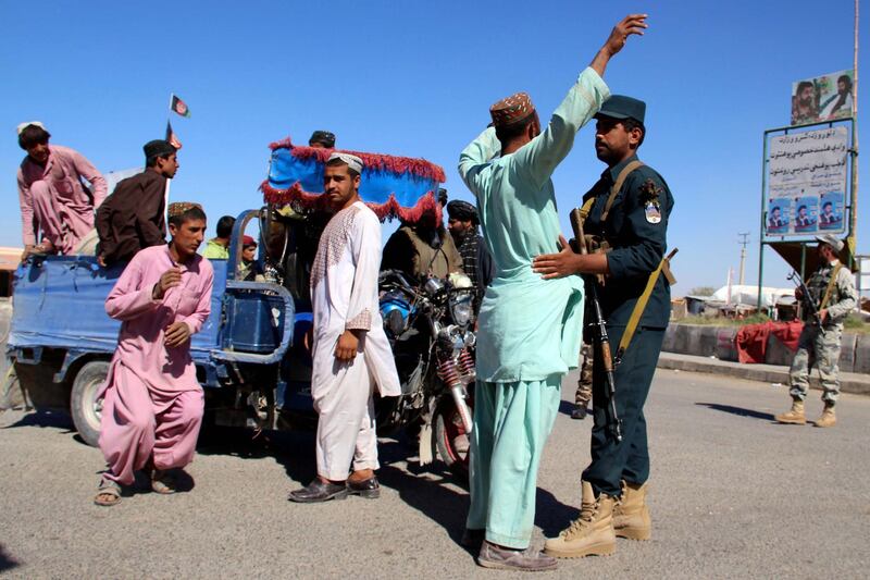 epa07104745 Afghan security officials check people and vehicles on a road side as security has been intensified ahead of parliamentary elections in Helmand, Afghanistan, 19 October 2018. More than 2,500 candidates are running for the 249 seats in the Afghan Parliament, with the Oct. 20 elections denounced by insurgents as a flawed process aimed at legitimizing the presence of foreign troops in Afghanistan. The Afghan government has deployed 54,000 soldiers to secure the peace during the polls, but 2,384 of the 7,384 polling stations are in areas under Taliban control and will remain closed on election day, according to the country's Independent Election Commission.  EPA/WATAN YAR