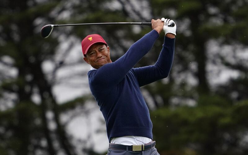 Playing Captain Tiger Woods of the USA team plays a shot. AFP