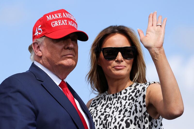 First lady Melania Trump waves next to President Donald Trump before a campaign rally outside Raymond James Stadium in Tampa, Florida. Reuters