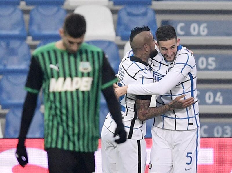 Inter Milan's Roberto Gagliardini celebrates scoring their third goal with Arturo Vidal. Reuters