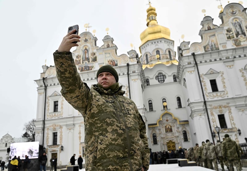 A Ukrainian serviceman takes a selfie in the grounds of Kyiv's Pechersk Lavra monastery. AFP