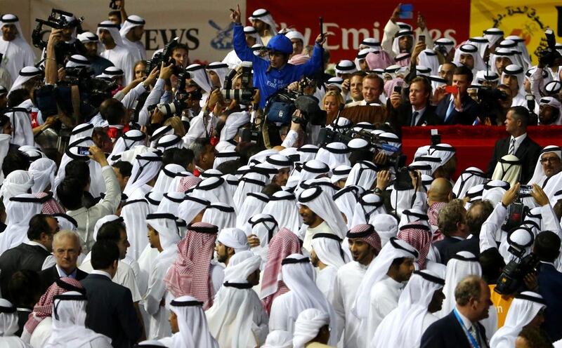 Brazilian jockey Silvestre De Sousa, centre, celebrates after winning the 19th Dubai World Cup for Sheikh Mohammed bin Rashid last year with African Story. Marwan Naamani / AFP