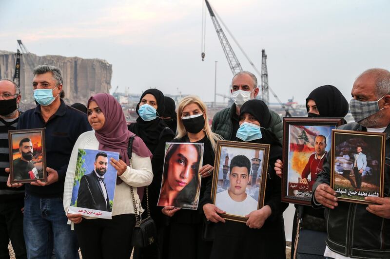 epa08919101 Relatives of victims of the 04 August Beirut port explosion pose with portraits of the deceased relatives, during a protest in Beirut, Lebanon, 04 January 2021. Relatives of people who died in the massive Beirut Port explosion on 04 August 2020 expressed their protest against the no-show of the Lebanese finance and public works ministers before a judge investigating the explosion. Former ministers are charged with negligence leading to deaths over the 04 August explosion at Beirut port, in which at least 200 people were killed and more than 6,000 were injured when a massive blast, believed to have been caused by an estimated 2,750 tons of ammonium nitrate stored in a warehouse, devastated the port area of Beirut and several parts of the city.  EPA/NABIL MOUNZER