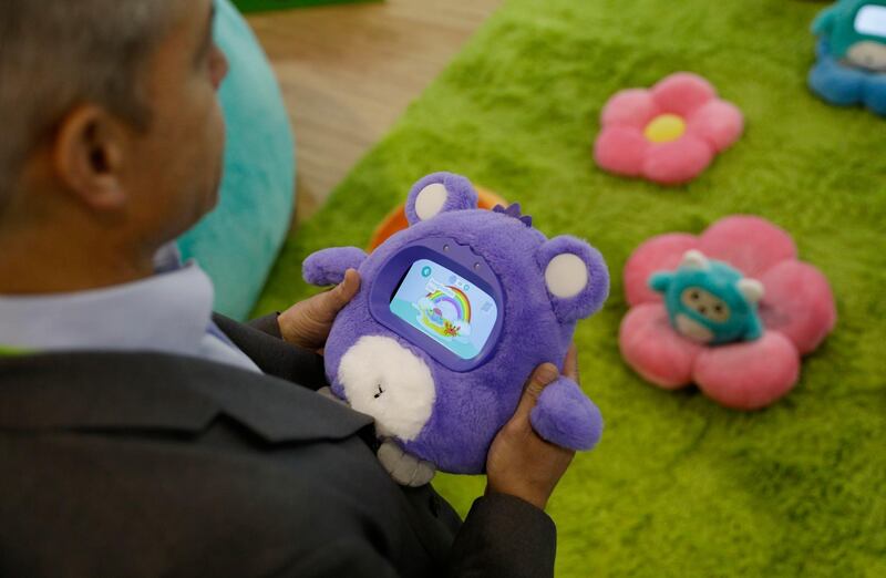 A man holds a Woobo talking robot at the Woobo booth. AP Photo
