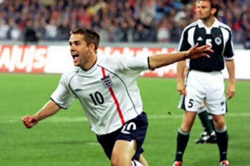 The England forward Michael Owen wheels away in celebration after scoring the second of his three goals in his side's 5-1 win over Germany in a World Cup qualifying match in Munich.