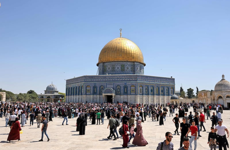 Palestinians gather around the Dome of the Rock shrine at the Al Aqsa Mosque compound, after Friday prayers. AFP