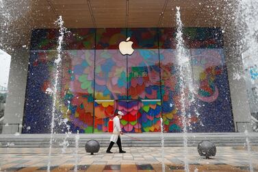 A worker sprays disinfectant outside the new Apple flagship store in Beijing. Reuters 