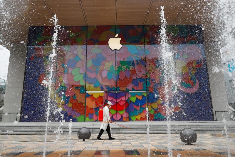A worker sprays disinfectant outside the new Apple flagship store in Sanlitun after an outbreak of the coronavirus disease (COVID-19) in Beijing, China July 13, 2020. REUTERS/Thomas Peter